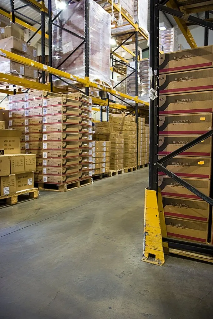 Organized warehouse inventory with stacked boxes on industrial storage racks