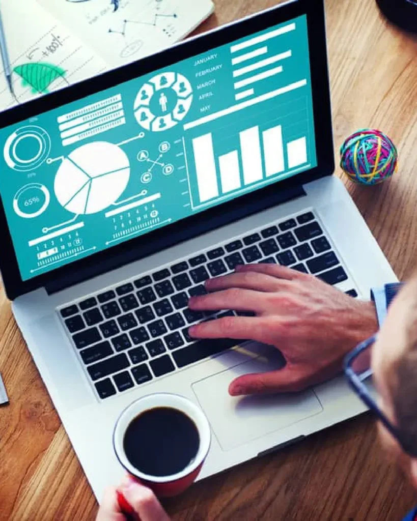 Performance management dashboard showing employee metrics, charts, KPIs, and performance data on a laptop screen